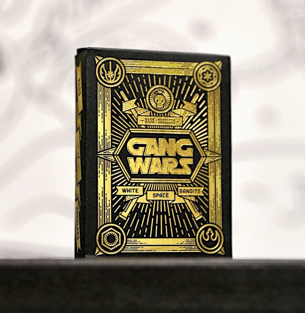 A deck of 52 playing cards and 2 joker cards all uniquely designed by Band of Doodlers bandits. Each deck also comes with a blank card for you to doodle on. A long time ago in a galaxy far, far away, feuding gangs clashed culminating in an epic showdown. On one side, the coalition between the Imperial Yakuza Warriors and the Dark Side Punk Hooligans. On the other, an alliance between the Cholo Crew Resistance Fighters and the Rebel Mafia Mob. This is the Gang Wars.