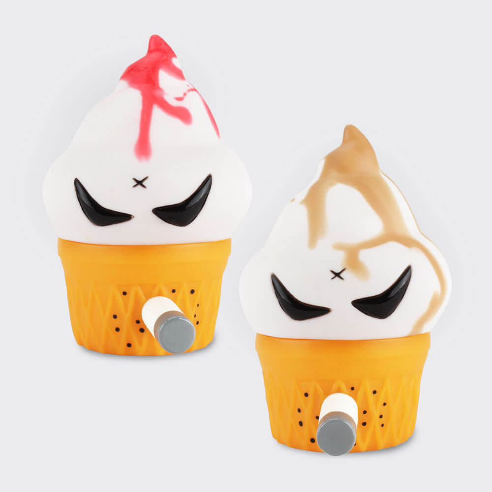 Frank Kozik's Jerome makes another SDCC Debut, this time with some randomly drizzled goodness joining the already announced Chocolate and Strawberry editions! Made with two colors of vinyl (that's not paint, it's literally in the vinyl), no two Caramel Drizzle or Cherry Drizzle Jeromes are the same. Jerome is articulated in one place, at the cone, and comes with a removable smork in case you prefer him to kick the habit (smoking is bad). Jerome is a soft vinyl slush cast figure designed by Frank Kozik, sculpted and produced by Squibbles Ink + Rotofugi. Drizzle Jeromes will be available at SDCC Booth 5248, Squibbles Ink + Rotofugi for $20 each (tax included) and also online at rotofugi.com for $17.95 each beginning Wednesday, July 20 at 8pm Central Time.